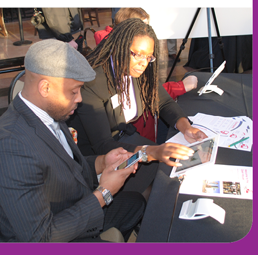 Photo: Two people using Digicate mobile at a meeting.